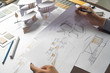 © Chaosamran_Studio - architect design working drawing sketch plans blueprints and making architectural construction model in architect studio