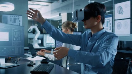 Wall Mural - computer science engineer wearing virtual reality headset works with 3d modeling, makes gestures. in