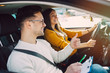 © hedgehog94 - Driving school or test. Beautiful young pregnant woman learning how to drive car together with her instructor.
