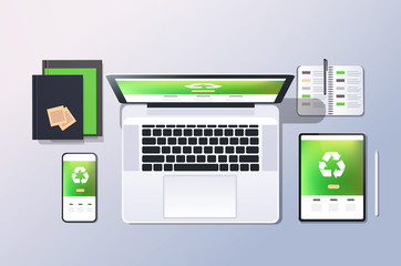 Wall Mural - mobile computer recycle application recycling concept top angle view desktop laptop smartphone table