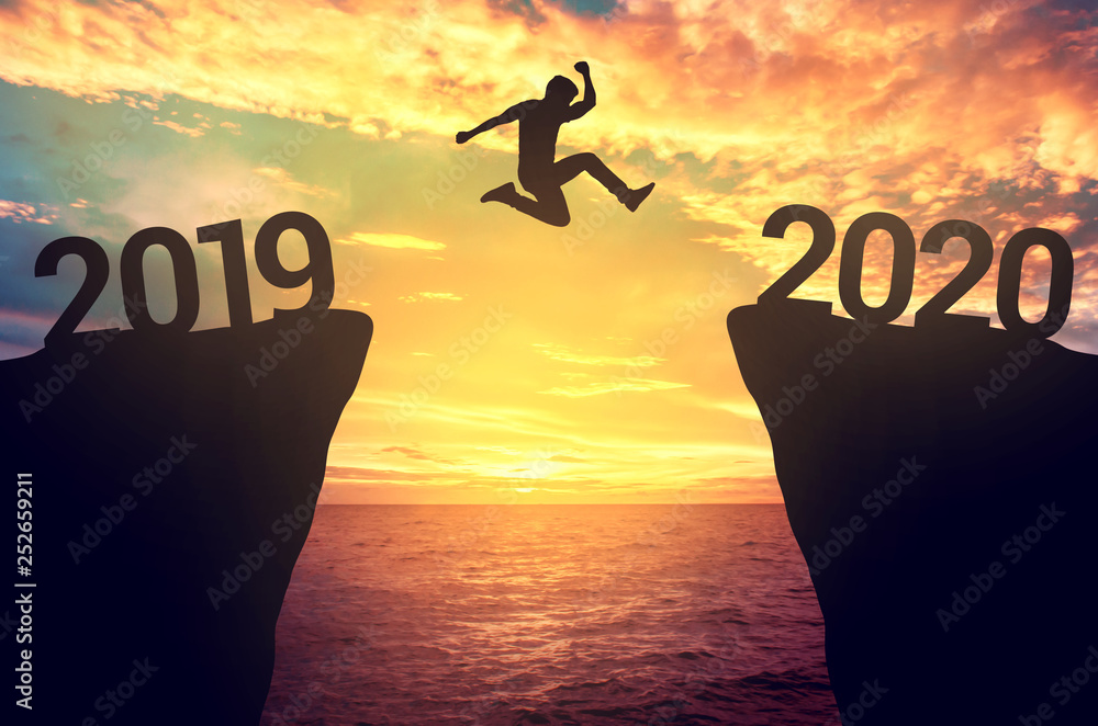 Businessman jump between 2019 and 2020 years. - obrazy, fototapety, plakaty 