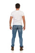 © studioloco - Young Man In Jeans And WhiteT-shirt Is Standing Relaxed, Rear View
