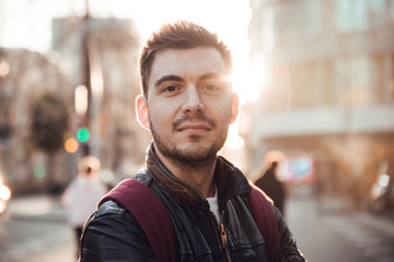 Close up of man with beard smiling at sunset in Barcelona city