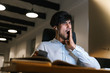 © Drobot Dean - Tired young business man working late at night