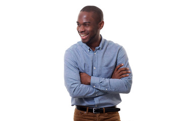 Wall Mural - handsome young african american man smiling with arms crossed by white background