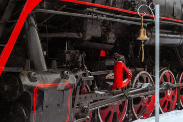 Wall Mural - closeup of a steam locomotive wheels with station bell