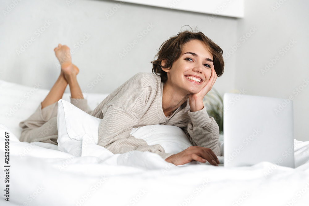 Smiling young girl relaxing in bed