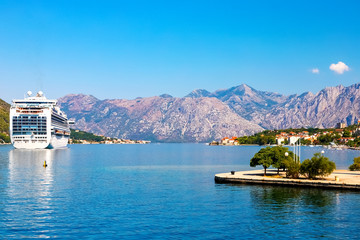 Wall Mural - Incredible bright seascape. View of green wooded mountains and blue sea, blue sky and white clouds. Boka Kotorska Bay, Montenegro