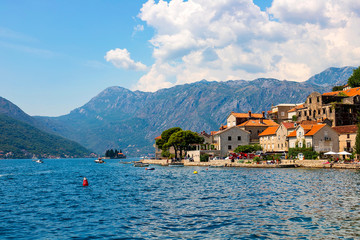 Wall Mural - Scenic panoramic view of the historical city of Perast, located in the Bay of Kotor on a sunny day with blue sky and white clouds in summer, Montenegro, southern Europe