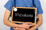 Fototapeta  - Doctor shows information on blackboard: Microbiota.  Medical concept.