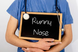 Fototapeta  - Doctor shows information on blackboard: runny nose.  Medical concept.
