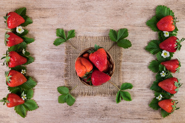 Canvas Print - Ripe strawberries creative decorated on rustic background. Top view