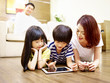 © imtmphoto - asian mother and two children using digital tablet together