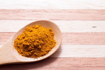 Wall Mural - Turmeric powder on wooden background