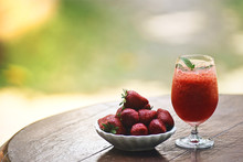 Strawberry Smoothie And Fresh Strawberry Above Wooden Table On Blurred Background. Selective Focus