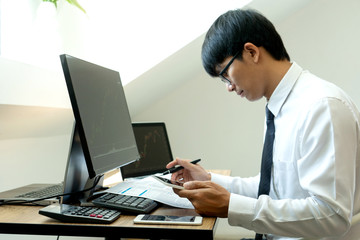 Poster - business man  sit at ther table looking at computer laptop in the office