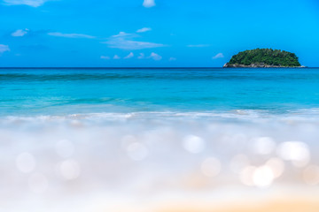 Wall Mural - blur tropical beach with bokeh sun light wave abstract background.