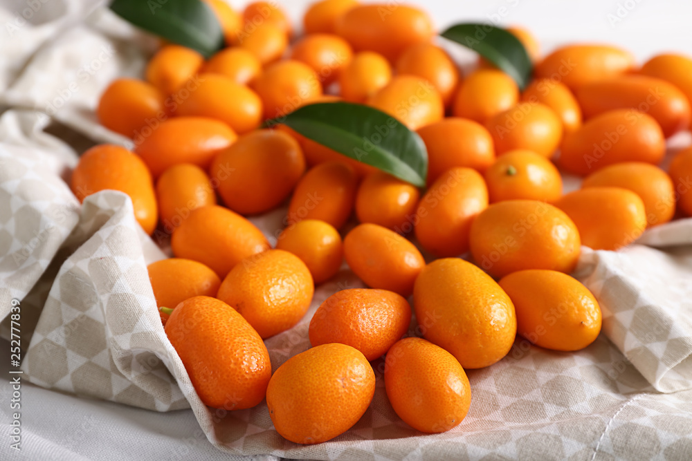 Delicious kumquat fruit on table