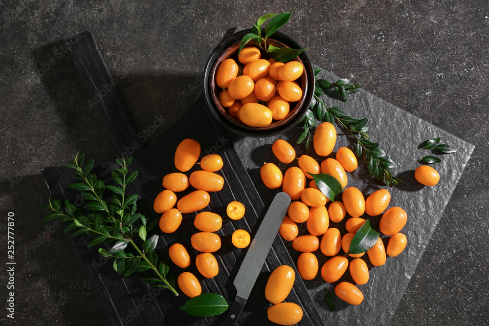 Composition with delicious kumquat fruit on table