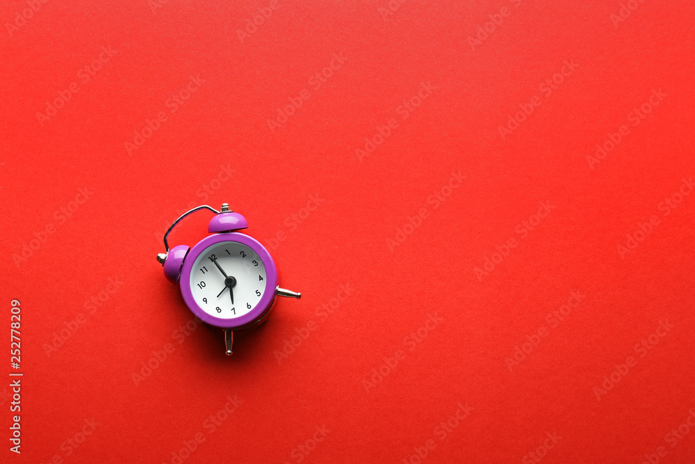 Alarm clock on color background