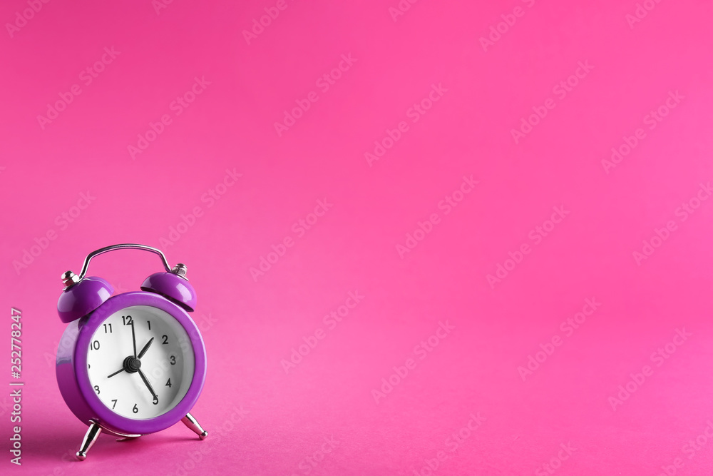 Alarm clock on color background