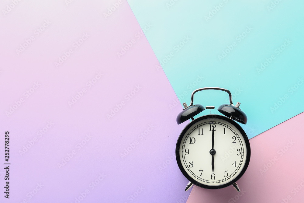 Alarm clock on color background