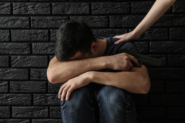 Wall Mural - Woman stopping young man with gun from committing suicide