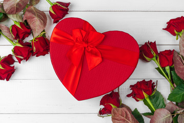 Wall Mural - St. Valentines Day. Red roses and gift box on wooden table