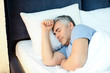 © Pixel-Shot - Mature man sleeping in bed at home