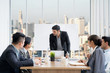 © paulfourk - Businesspeople discussing together in conference room during meeting at office.