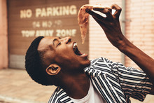African Man Eating Pizza