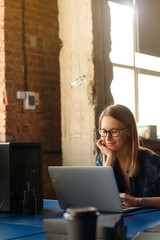 Wall Mural - A girl works at a computer in a modern office