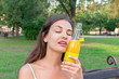 © sosiukin - Young beautiful woman tries to refresh with a cold bootle of juice in a hot summer day