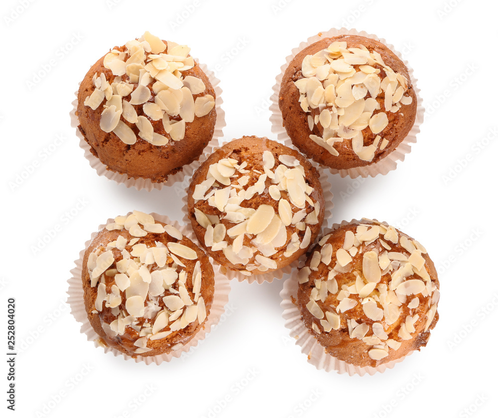 Tasty almond muffins on white background