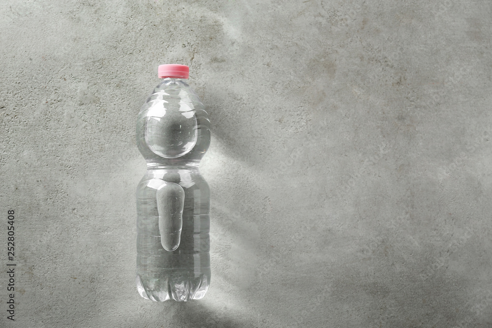 Bottle of clean water on grey background