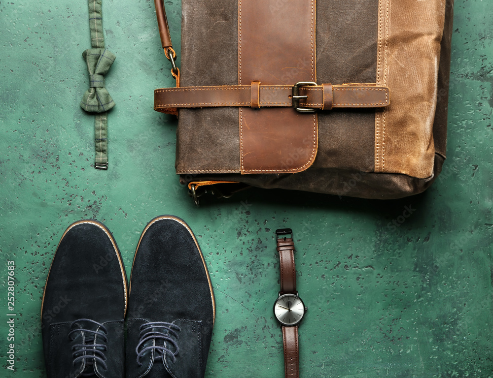 Set of male accessories on color background
