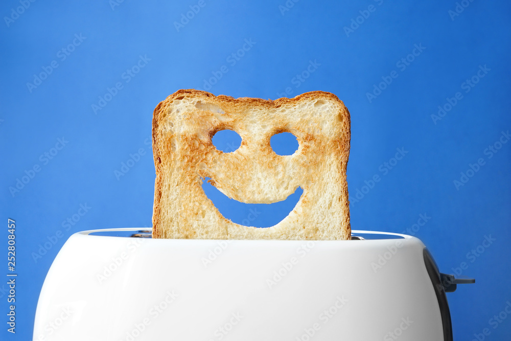Funny slice of bread with toaster on color background