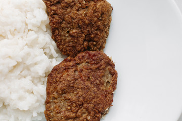 Close up of two tasty fried burger meal with white rice. Declicious homemade food for dinner.