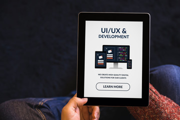 Wall Mural - hands holding tablet with ui/ux design and development concept on screen