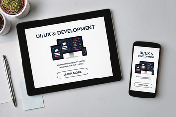 Wall Mural - ui/ux design and development concept on tablet and smartphone screen