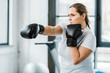 confident overweight girl practicing kickboxing in gym