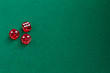 © ukrolenochka - Red dice on green and black background. Copy space for text