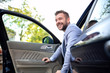 © didesign - Smiling man exiting his vehicle