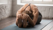 © fizkes - Beautiful woman practicing yoga, Seated forward bend pose, paschimottanasana