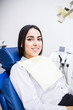 © F8  \ Suport Ukraine - Young female patient visiting dentist office. Beautiful smiling woman with healthy straight white teeth sitting at dental chair. Dental clinic. Stomatology