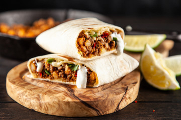 Wall Mural - Mexican burrito with beef, beans and sour cream