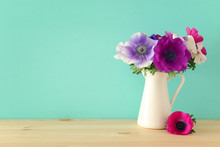 Spring Bouquet Of Colorful Anemones In The Vase Over Wooden Table