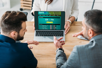 selective focus of advisor showing to investors laptop with sportsbet website on screen