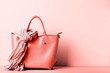 Female handbag with scarf on living coral background