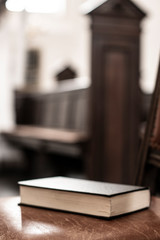 Wall Mural - Songbook lies on the old bench in the church